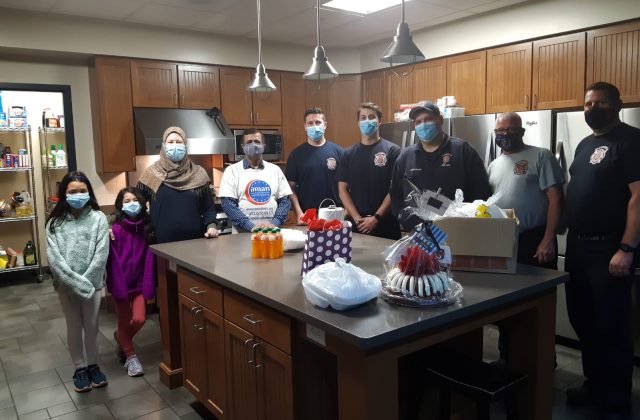 AMAN volunteers holding gift baskets prepared for Plainfield firefighters