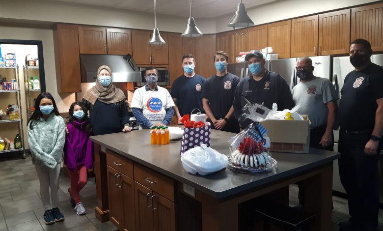 AMAN volunteers holding gift baskets prepared for Plainfield firefighters