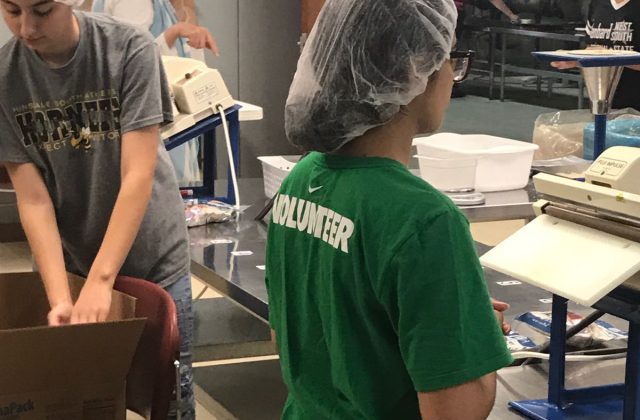 AMAN volunteer packing meals at Feed My Starving Children in Aurora, Illinois