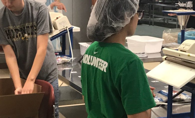 AMAN volunteer packing meals at Feed My Starving Children in Aurora, Illinois